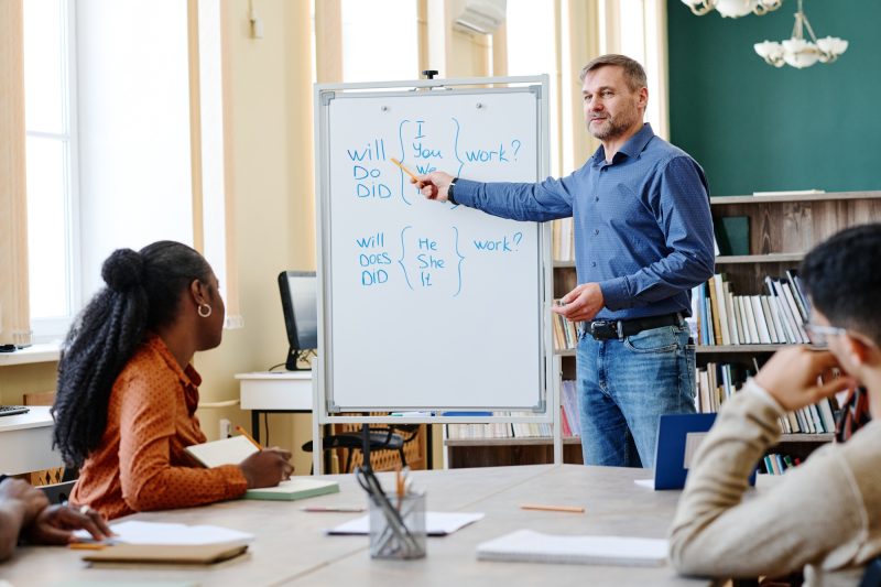 Man Teaching Migrants English